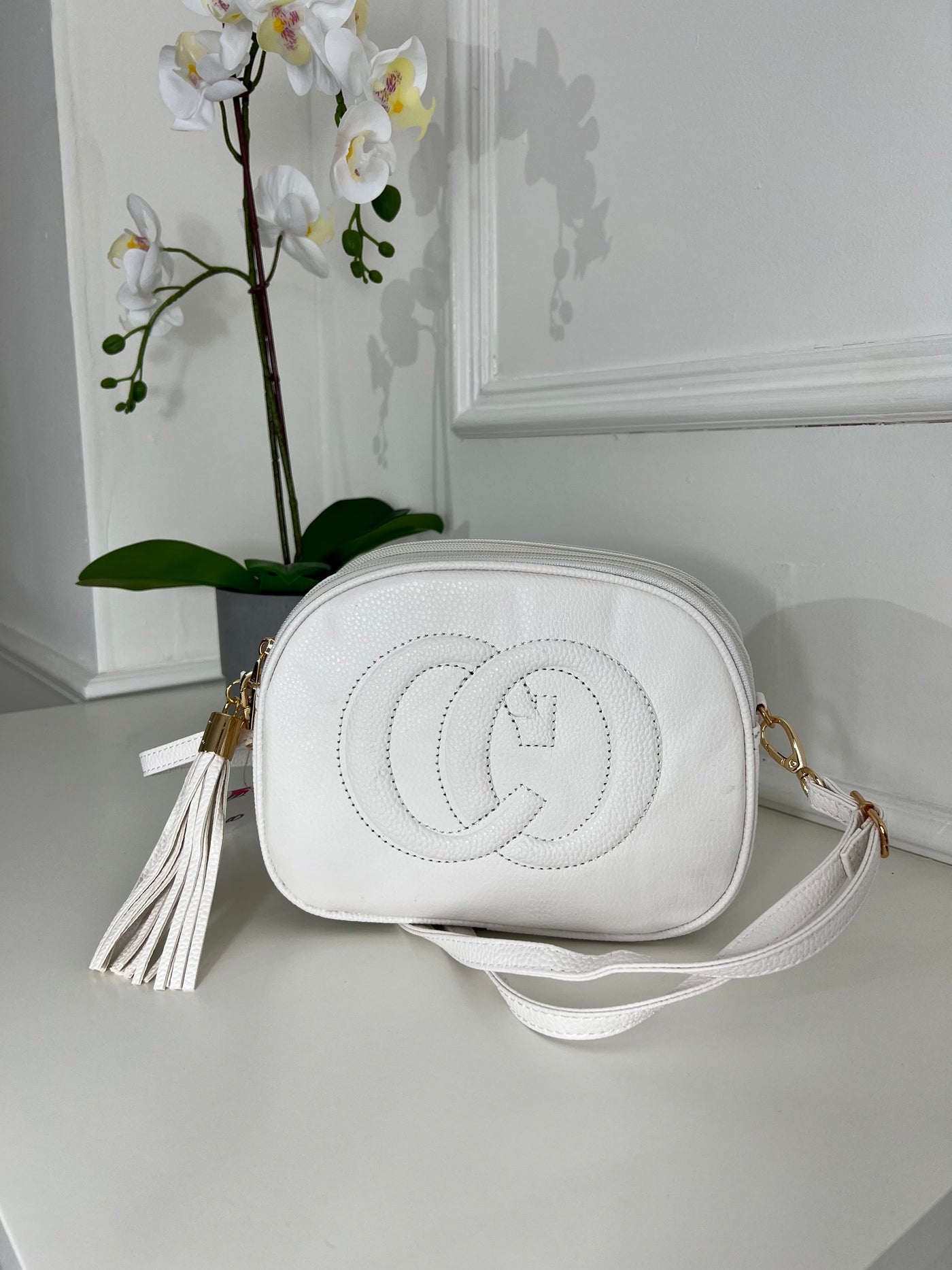 White CO embraided cross bag with tassel