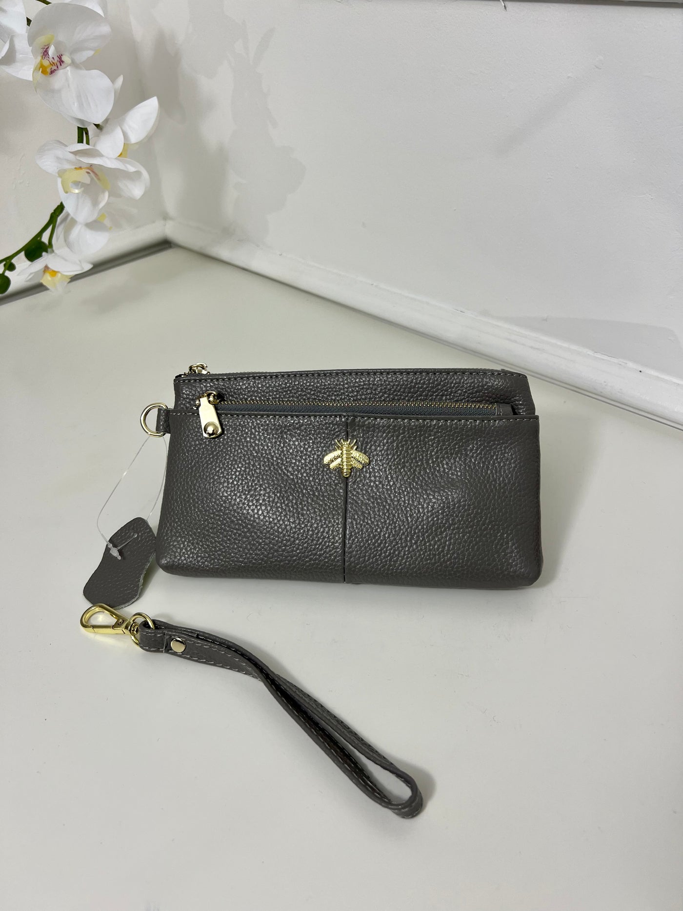 Grey purse with a strap bee detail