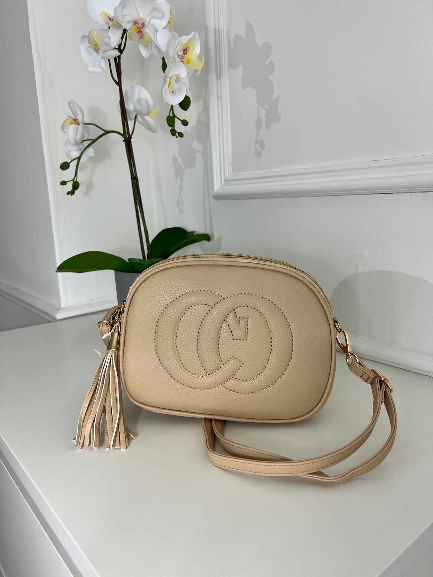 Nude CO embraided cross bag with tassel