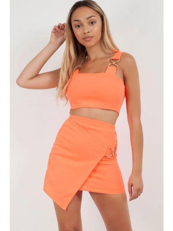 orange two piece gold buckle skirt and crop