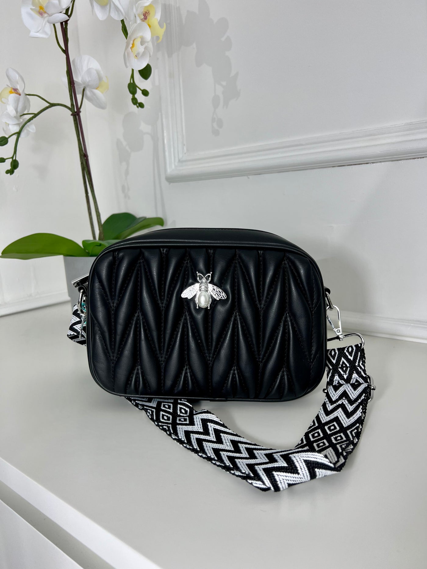 Black quilted pattern strap bag